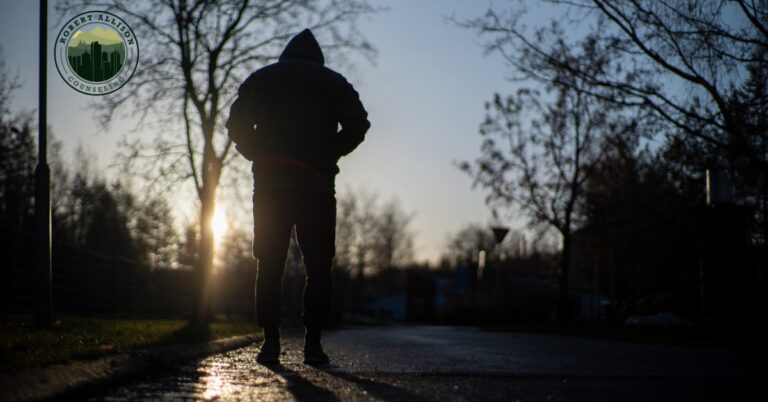 Depressed man walking on dark winter day.