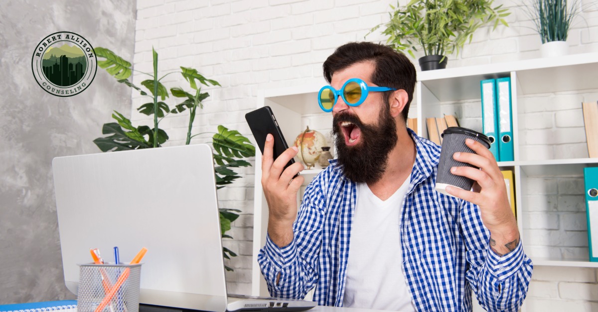 Anxious man taking on too many tasks as desk