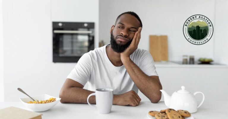 apathetic man sitting at table