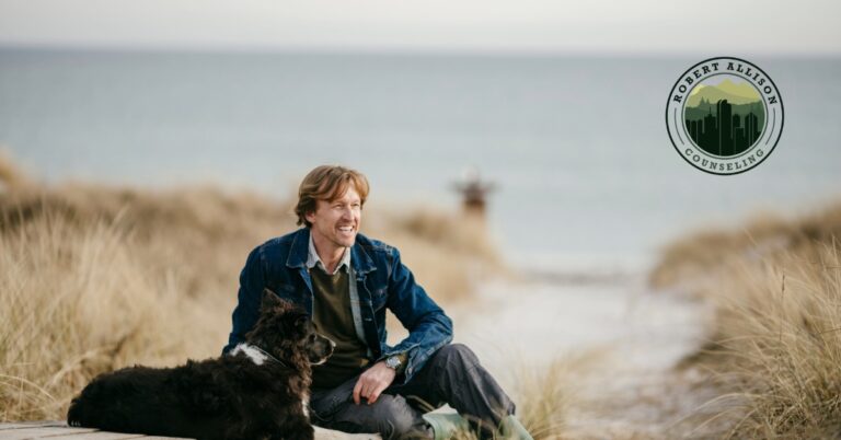 Man enjoying moment on beach with dog