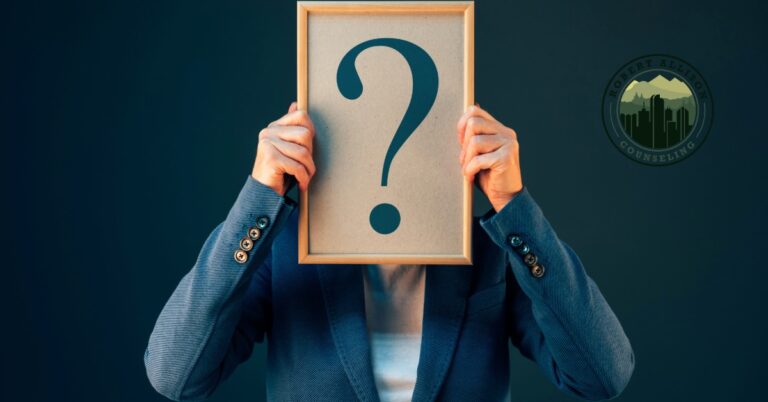 Man hiding behind question mark